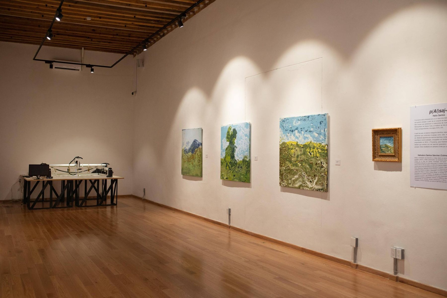 Gallery view with paintings and the machine at the back